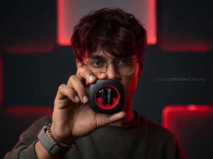 A user holding the CTRL8 K7 true wireless earbuds against a modern red-lit backdrop, highlighting AI ENC-P technology.