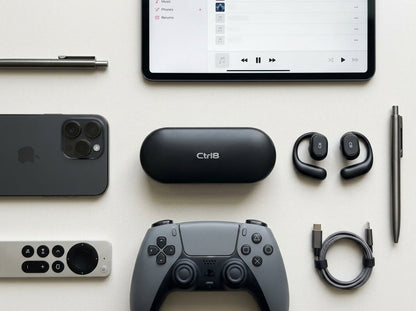 CTRL8 X29 open-ear headphones with charging case placed alongside gaming and tech accessories for immersive audio experience